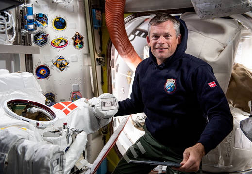 astronaut-andreas-mogensen-works-on-a-spacesuit-with-his-nations-flag-patch 53234678884 o