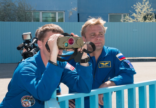 15-49-09 At the Baikonur Cosmodrome in Kazakhstan, Expedition 40 41 Flight Engineer Reid Wiseman of NASA (left) peers through high-powered binoculars during a training session May 16 as Soyuz Commander Max Surae o