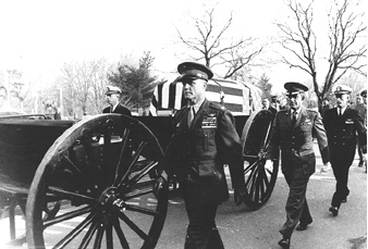 The flag draped coffin of Astronaut Virgil I. Grissom is being escorted at Arlington Cemetery, Va., by his fellow astronauts